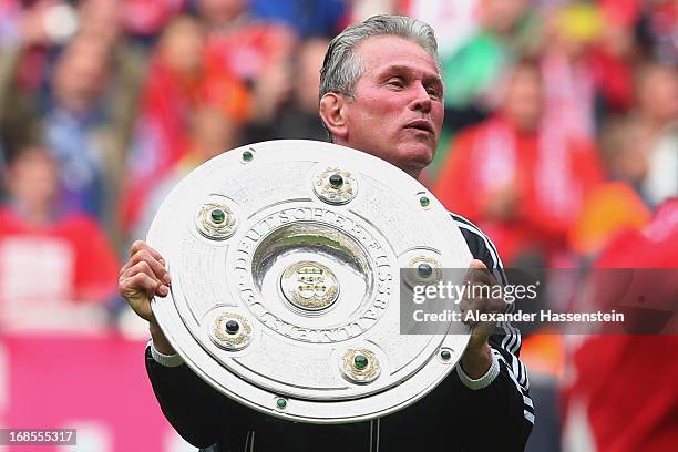 Jupp Heynckes, head coach of FC Bayern Muenchen celebrates with the Bundesliga trophy following his team's match against Augsburg at the Allianz...