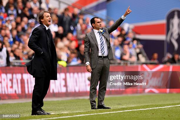 Manager Roberto Mancini of Manchester City shouts as manager Roberto Martinez of Wigan Athletic signals during the FA Cup with Budweiser Final...