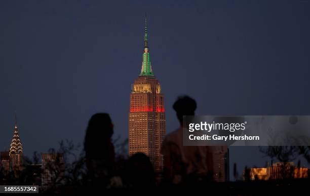 The Empire State Building lights in red, white, and green to mark Mexican Independence Day in New York City on September 16 as seen from Jersey City,...