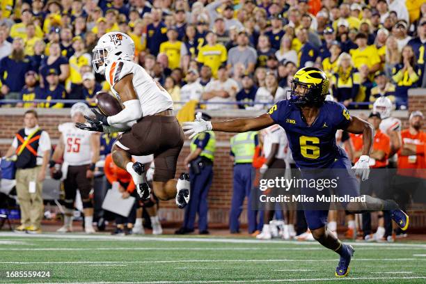 Jordan Oladokun of the Bowling Green Falcons intercepts a pass intended for Cornelius Johnson of the Michigan Wolverines in the second quarter of a...