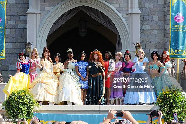 The Disney Princess royal court with Gabby Douglas and her mom Natalie Hawkins pose during a royal celebration at the Magic Kingdom at Walt Disney...