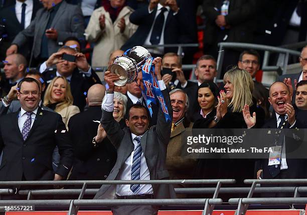Wigan Athletic manager Roberto Martinez celebrates as he lifts the trophy after victory in the FA Cup with Budweiser Final match between Manchester...