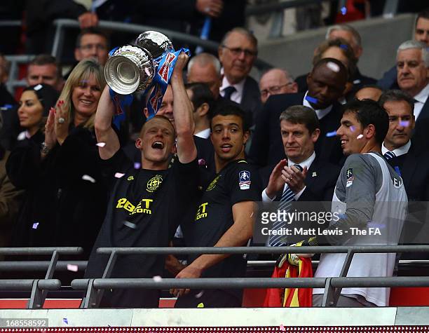 Goalscorer Ben Watson of Wigan Athletic celebrates as he lifts the trophy after victory in the FA Cup with Budweiser Final match between Manchester...