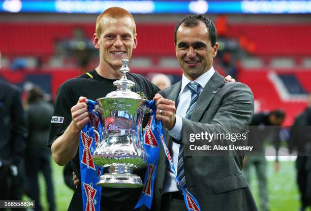 Manager Roberto Martinez of Wigan Athletic and winning goalscorer Ben Watson celebrate with the trophy following their team's 1-0 victory during the...