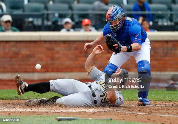Michael McKenry scores on a single by Clint Barmes as catcher John Buck of the New York Mets can't handle the throw in the fifth inning during a game...