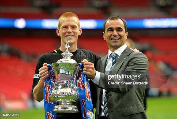 Manager Roberto Martinez of Wigan Athletic and winning goalscorer Ben Watson celebrate with the trophy following their team's 1-0 victory during the...