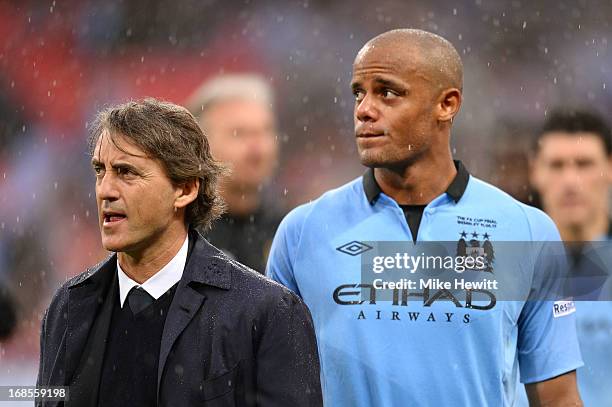 Manager Roberto Mancini of Manchester City and Vincent Kompany look dejected in defeat after the FA Cup with Budweiser Final between Manchester City...