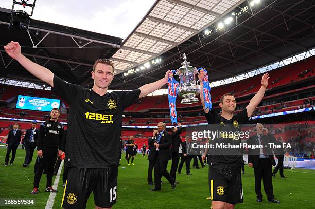 Callum McManaman and Shaun Maloney of Wigan Athletic celebrate with the trophy after victory in the FA Cup with Budweiser Final match between...