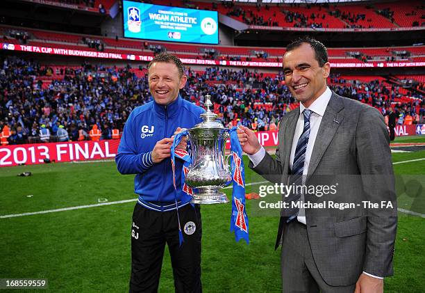 Wigan Athletic assistant manager Graham Jones and manager Roberto Martinez celebrate with the trophy after victory in the FA Cup with Budweiser Final...