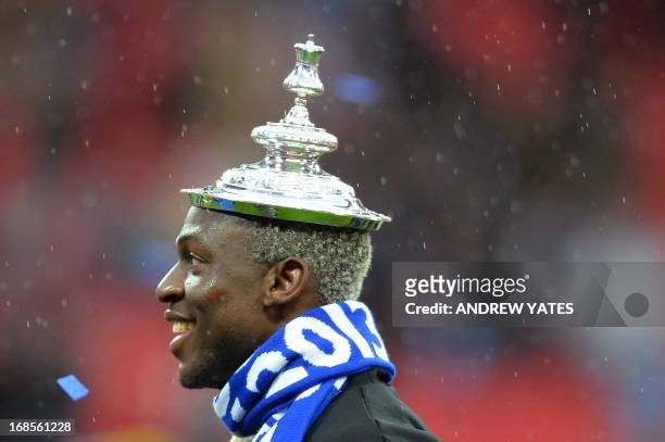 Wigan Athletic's Ivorian striker Arouna Kone poses with the lid of the FA Cup on his head after winning the English FA Cup final football match...