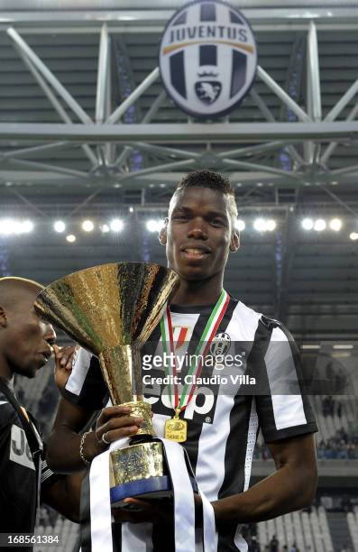 Paul Pogba of Juventus FC celebrates with the Serie A trophy after the Serie A match between Juventus and Cagliari Calcio at Juventus Arena on May...