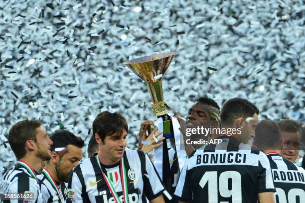 Juventus' players celebrate with the trophy during the ceremony of the Scudetto, the Italian Serie A trophy after the Italian Serie A football match...