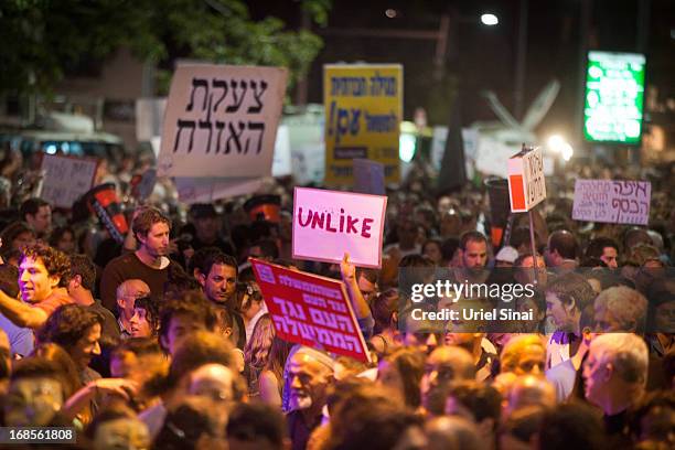 Demonstrators march through the streets to protest against Israeli Finance Minister Yair Lapid's budget cuts on May 11, 2013 in Tel Aviv, Israel....