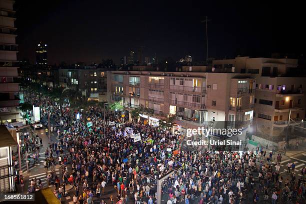 Demonstrators march through the streets to protest against Israeli Finance Minister Yair Lapid's budget cuts on May 11, 2013 in Tel Aviv, Israel....