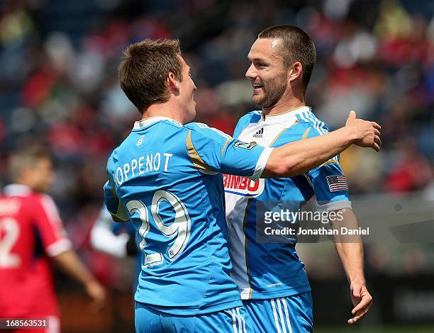 Jack McInerney of the Philadelphia Union celebrates with teammate Antoine Hoppenot after scoring the game winning goal against Chicago Fire during an...