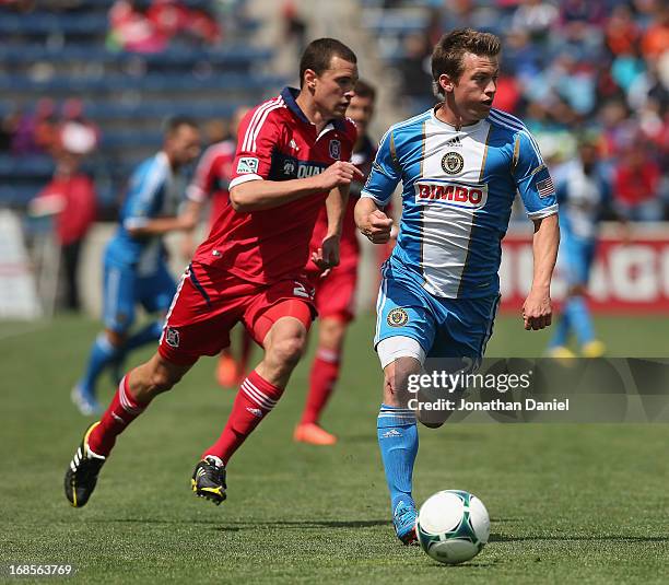 Antoine Hoppenot of the Philadelphia Union controls the ball chased by Austin Berry of the Chicago Fire during an MLS match at Toyota Park on May 11,...