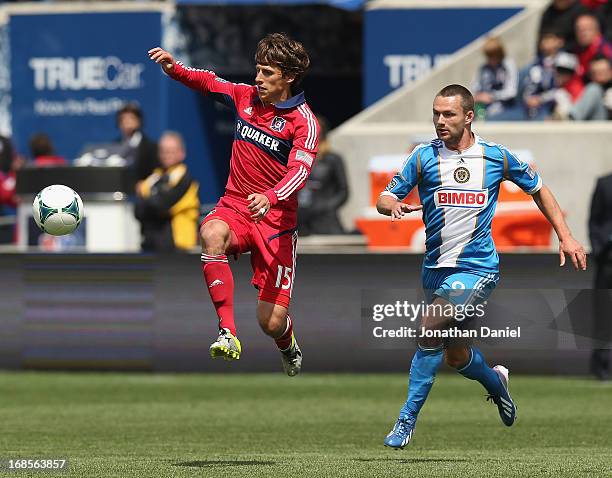 Wells Thompson of the Chicago Fire chases down the ball in front of Jack McInerney of the Philadelphia Union during an MLS match at Toyota Park on...