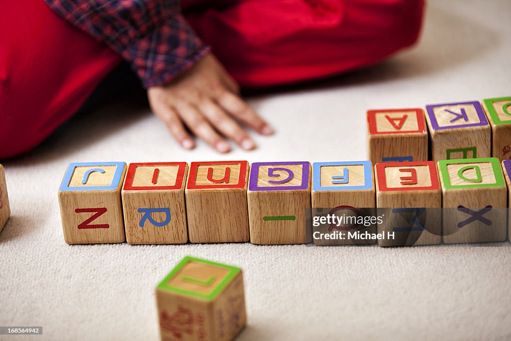 Girl playing with blocks on the floor