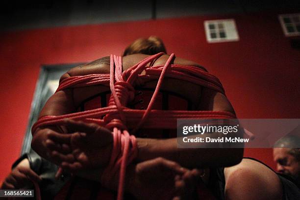 Participant called SgChill is bound in rope at a dungeon party during the domination convention, DomConLA, in the early morning hours of May 11, 2013...