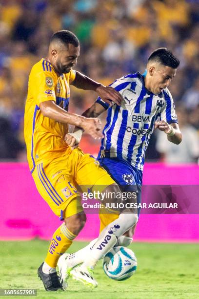 Tigres' Brazilian midfielder Rafael Carioca fights for the ball with Monterrey's Argentine midfielder Maximiliano Meza during the Mexican Apertura...