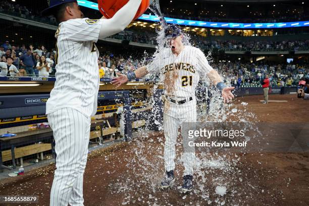 Willy Adames of the Milwaukee Brewers douses teammate, Mark Canha with water after defeating the Washington Nationals 9-5 at American Family Field on...