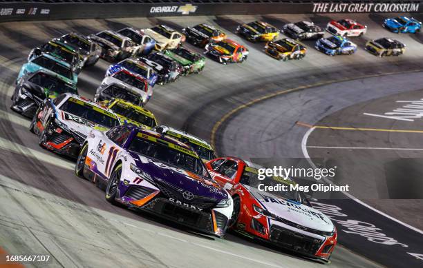 Denny Hamlin, driver of the FedEx Freight Direct Toyota, and Kyle Larson, driver of the Valvoline/Hendrickcars.com Chevrolet, lead the field during...