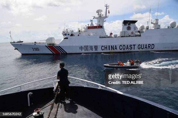 This photo taken on September 22, 2023 shows Chinese coast guard ship blocking a Philippine Bureau of Fisheries and Aquatic Resources' ship while its...
