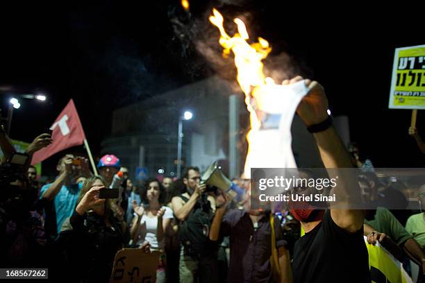 Demonstrators march through the streets to protest against Israeli Finance Minister Yair Lapid's budget cuts on May 11, 2013 in Tel Aviv, Israel....