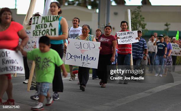 People march together during a rally calling on President Barack Obama to immediately suspend deportations and for Congress to pass an immigration...