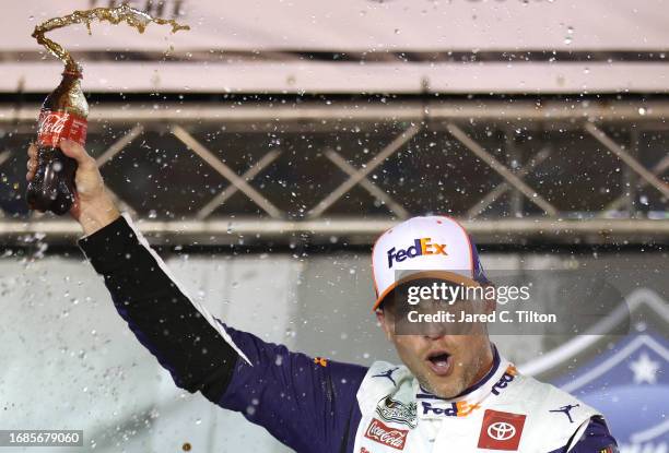 Denny Hamlin, driver of the FedEx Freight Direct Toyota, celebrates in victory lane after winning the NASCAR Cup Series Bass Pro Shops Night Race at...