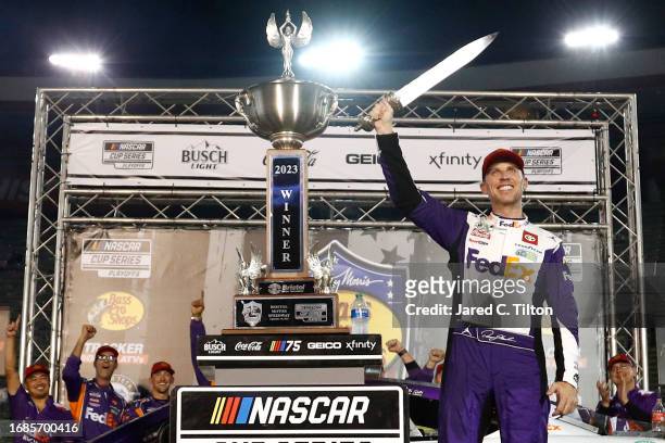 Denny Hamlin, driver of the FedEx Freight Direct Toyota, celebrates in victory lane after winning the NASCAR Cup Series Bass Pro Shops Night Race at...