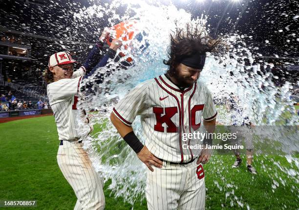 Logan Porter of the Kansas City Royals is splashed with water by Bobby Witt Jr. #7 and MJ Melendez after the Royals defeated the Houston Astros 10-8...