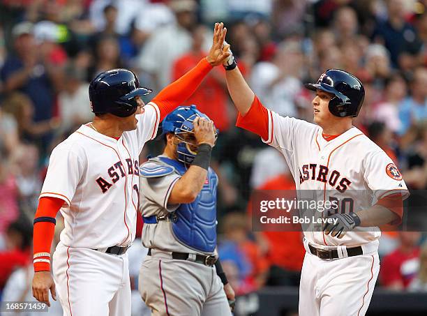 Matt Dominguez of the Houston Astros receives congratulations from Carlos Pena after hitting a home run in the fifth inning against the Texas...