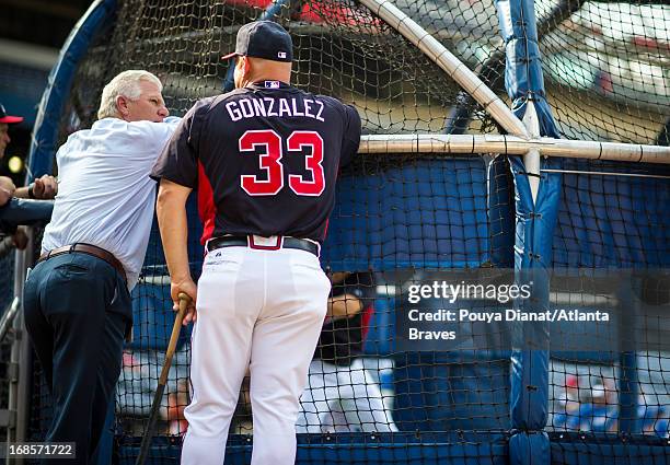 General manager Frank Wren speaks with manager Fredi Gonzalez of the Atlanta Braves before the game against the Kansas City Royals at Turner Field on...