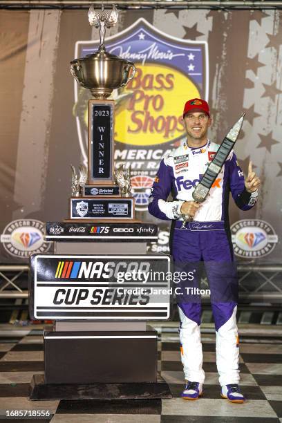 Denny Hamlin, driver of the FedEx Freight Direct Toyota, celebrates in victory lane after winning the NASCAR Cup Series Bass Pro Shops Night Race at...