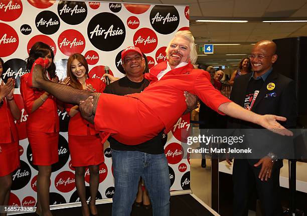 Sir Richard Branson and AirAsia CEO Tony Fernandes at Perth International Airport on May 12, 2013 in Perth, Australia. Branson shaved his legs, wore...