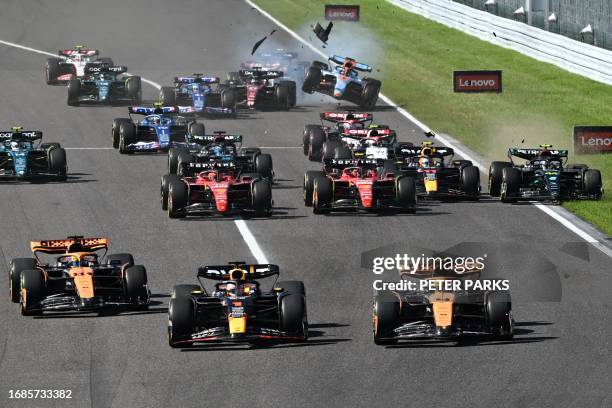 Red Bull Racing's Dutch driver Max Verstappen and McLaren's British driver Lando Norris drive ahead of McLaren's Australian driver Oscar Piastri as...