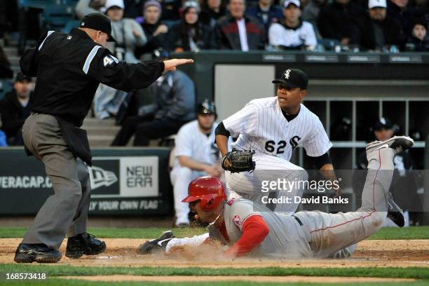 Albert Pujols of the Los Angeles Angels of Anaheim scores on a passed ball as Jose Quintana of the Chicago White Sox makes a late tag during the...
