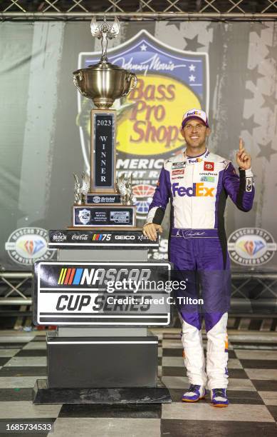 Denny Hamlin, driver of the FedEx Freight Direct Toyota, celebrates in victory lane after winning the NASCAR Cup Series Bass Pro Shops Night Race at...