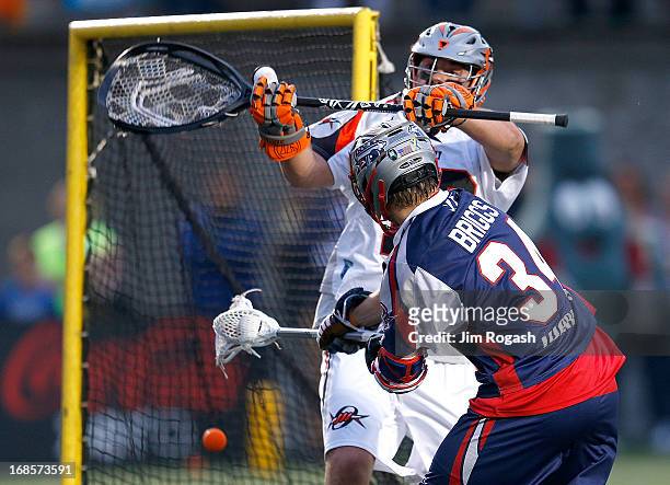 Jesse Schwartzman of the Denver Outlaws does not stop a shot by Colin Briggs of the Boston Cannons in the first half at Harvard Stadium on May 11,...