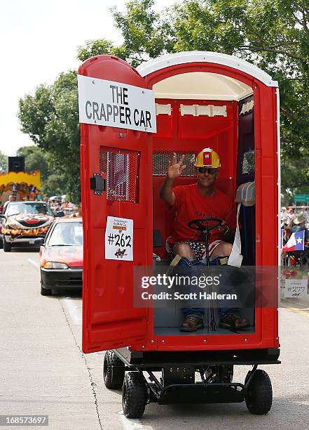 Paradegoer rides in an art car on Allen Parkway during the 26th Annual Houston Art Car Parade on May 11, 2013 in Houston, Texas.