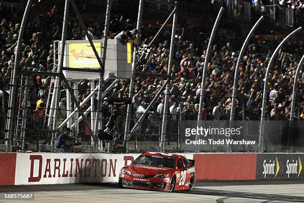 Matt Kenseth, driver of the The Home Depot / Husky Toyota, crosses the star/finish line to take the checkered flag and win the NASCAR Sprint Cup...