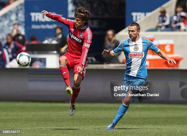 Wells Thompson of the Chicago Fire chases down the ball in front of Jack McInerney of the Philadelphia Union during an MLS match at Toyota Park on...