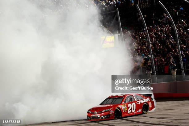 Matt Kenseth, driver of the The Home Depot / Husky Toyota, performs a burnout in celebration of winning the NASCAR Sprint Cup Series Bojangles'...