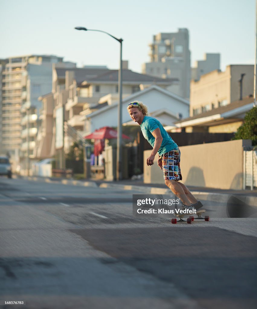 Skater riding on the road with longboard