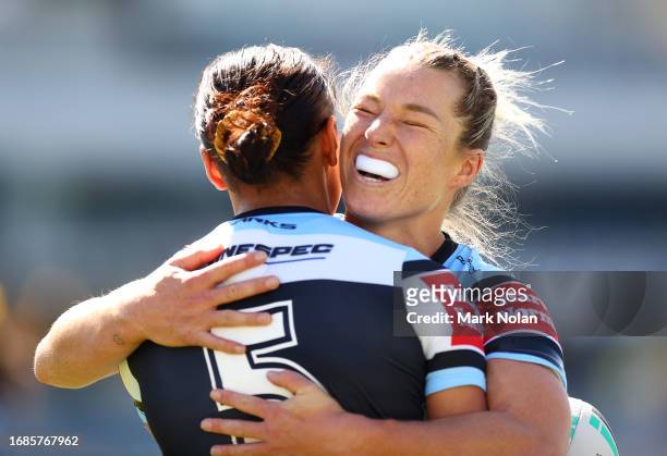 Emma Tonegato of the Sharks celebrates a try by Cassie Staples of the Sharks during the round nine NRLW match between Parramatta Eels and Cronulla...