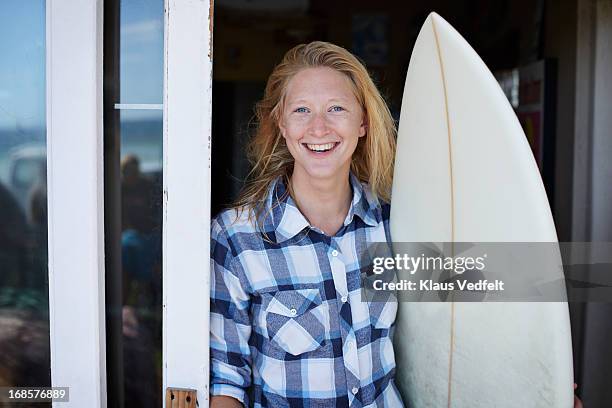 Cool surf girl laughing with surfboard