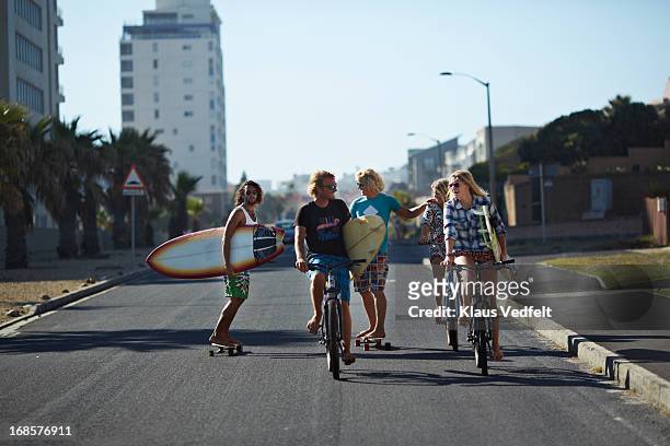 surfers on the way to the beach - city to surf stock pictures, royalty-free photos & images