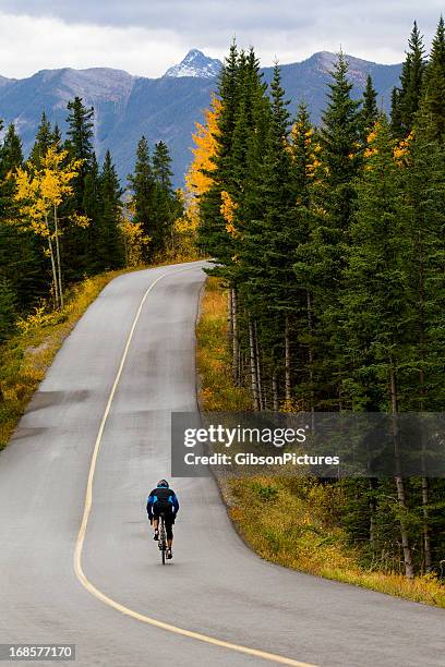 road biking in banff national park - uphill stock pictures, royalty-free photos & images
