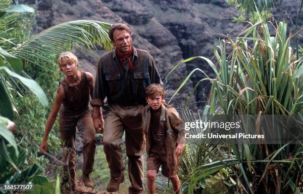 Ariana Richards walks with Sam Neill and Joseph Mazzello in a scene from the film 'Jurassic Park', 1993.